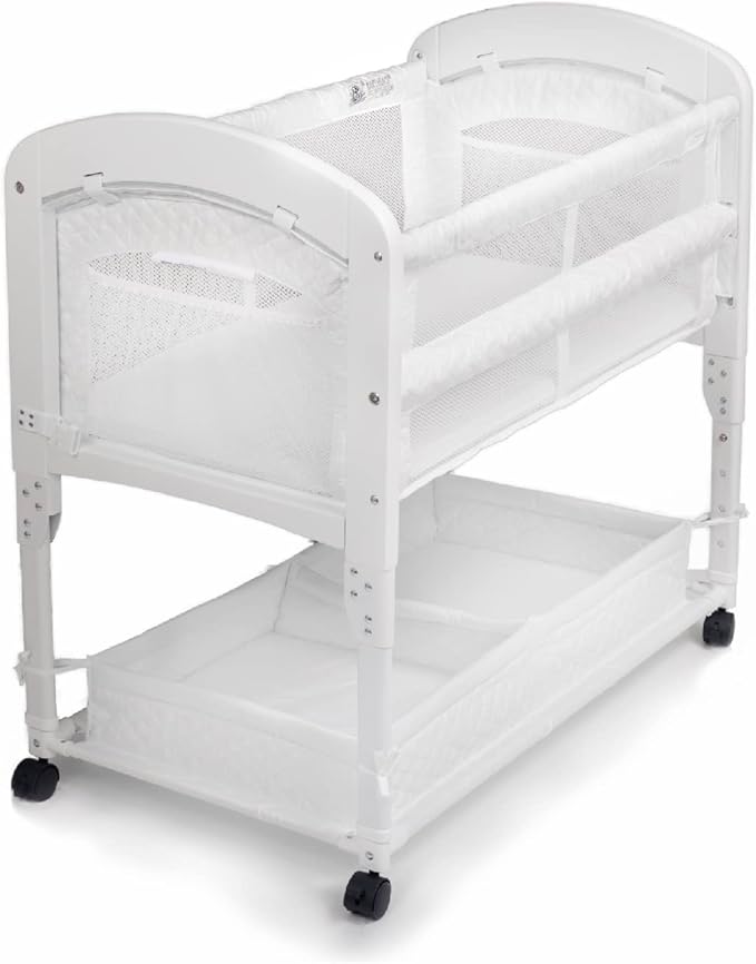 Arm’s Reach Cambria Co-Sleeper Bedside Bassinet Featuring Height-Adjustable Legs, Curved Wooden Ends, Breathable Mesh Sides with Pockets, and Large Lower Storage Basket, White