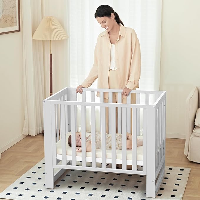 EvoNest Baby Crib, 6 in 1 Convertible Mini Crib with Wheels, 100% New Zealand Pinewood Growing Bed, 4 Adjustable Mattress Height, (Milk)