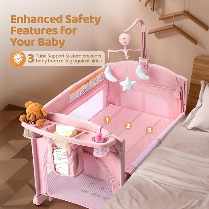 JOYMOR 9 in 1 Bedside Bassinet with Changing Table, Pack and Play with Bassinet, Convert to Rocking Baby Bed with Electric Music Center, Mosquito Net, Toy, Storage,Pink
