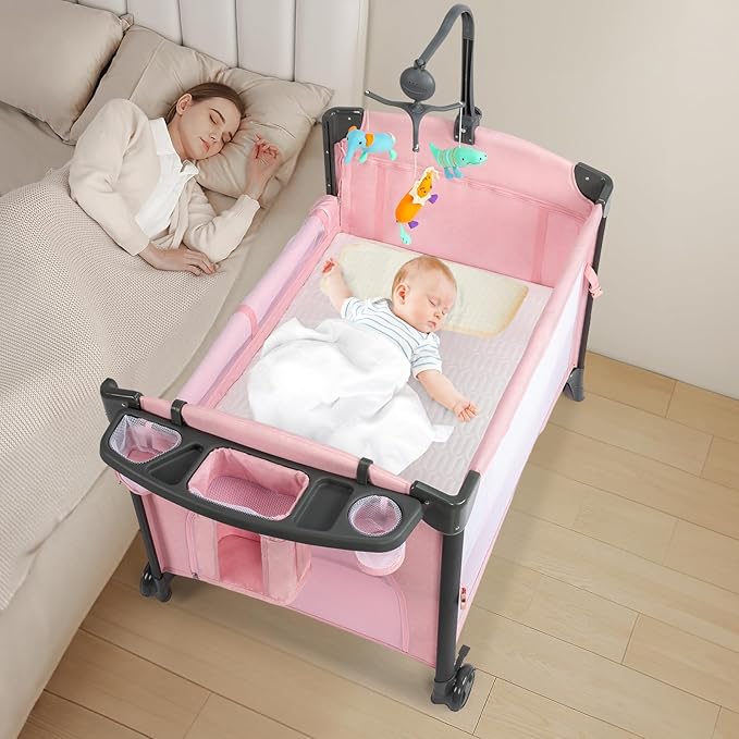 JOYMOR Twin Bassinet for Baby, Pink Bedside Bassinet, Convertible to Bedside Sleeper and Playpen, with Wheel, Brake, Foldable Side Sleeper
