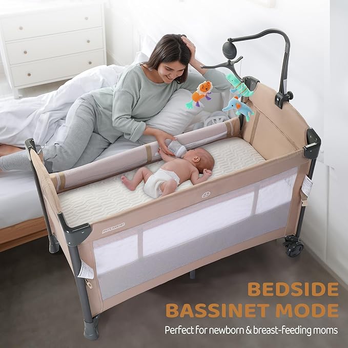 JOYMOR Baby Bedside Bassinet, Baby Bassinet, Pack n Play Convert Playpen, Quick Foldable Travel Bed with Toy, Wheels & Brake, Carry Bag for Boys Girls (Beige)