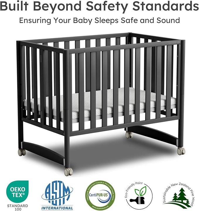 EvoNook 6-in-1 Convertible Mini Crib, 100% New Zealand Solid Wood, 4 Adjustable Mattress Heights, Black with Matttress