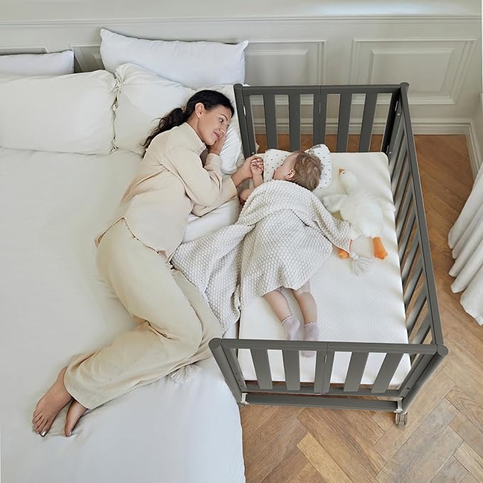 EvoNook 6-in-1 Convertible Mini Crib, 100% New Zealand Solid Wood, 4 Adjustable Mattress Heights, Black with Matttress
