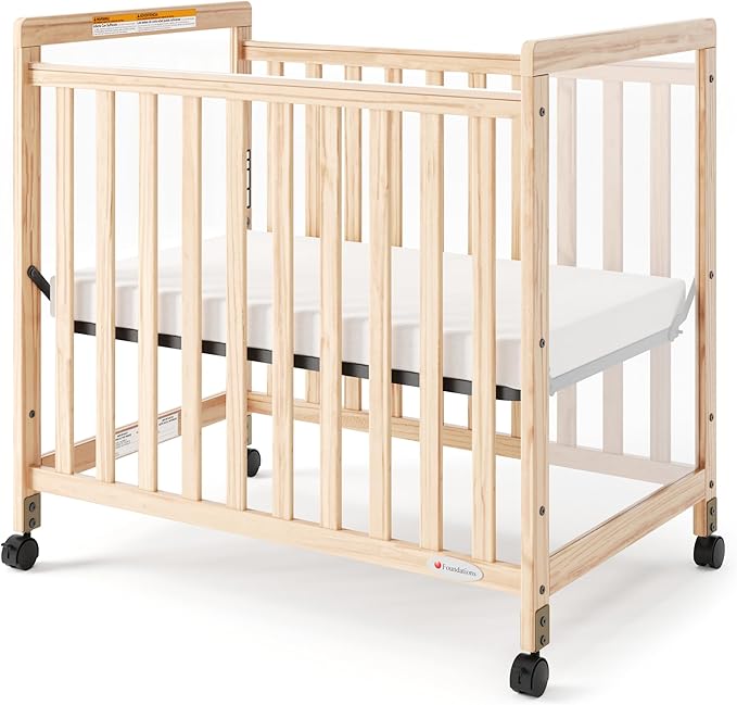Foundations SafetyCraft Clearview Compact Daycare Crib, Durable Wood Construction, Non-Marking Casters (2 Locking), Includes 3” InfaPure Foam Mattress (Natural)