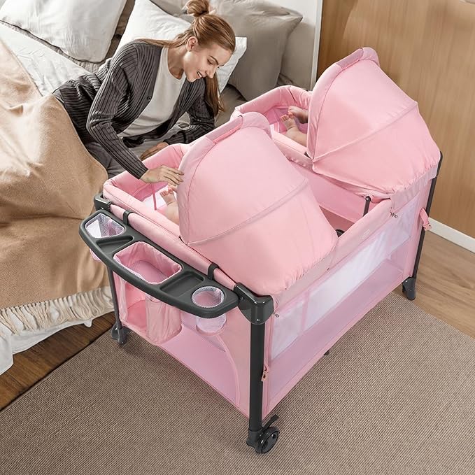 JOYMOR Twin Bassinet for Baby, Pink Bedside Bassinet, Convertible to Bedside Sleeper and Playpen, with Wheel, Brake, Foldable Side Sleeper