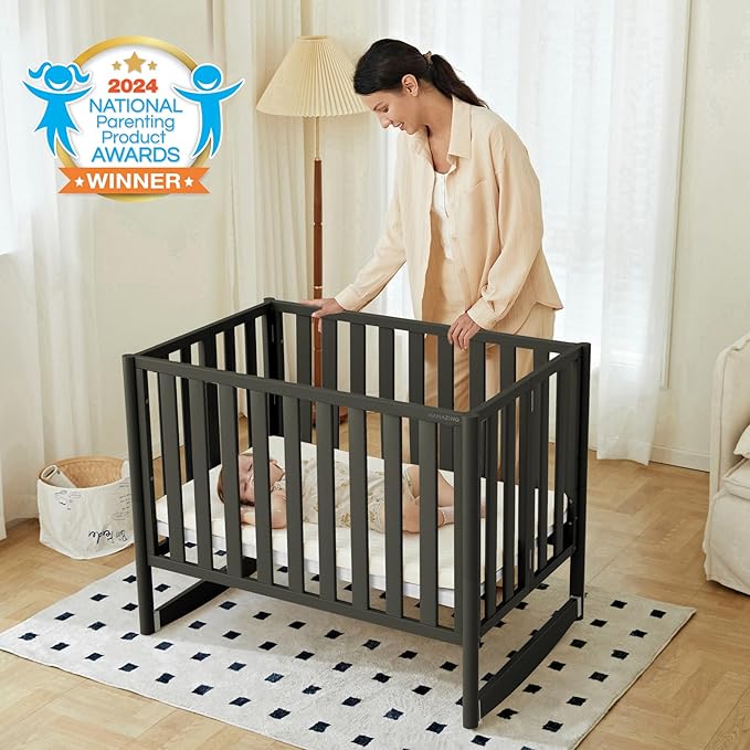 EvoNook 6-in-1 Convertible Mini Crib, 100% New Zealand Solid Wood, 4 Adjustable Mattress Heights, Black with Matttress