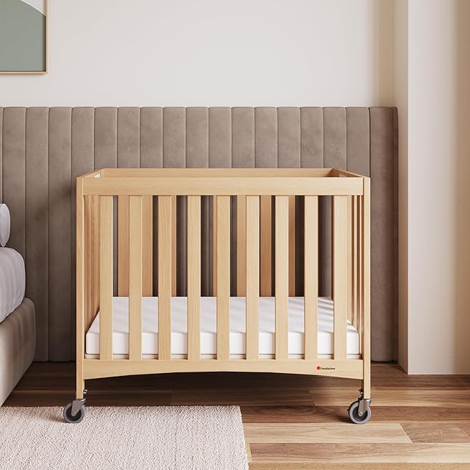 Foundations Travel Sleeper Wood Compact Folding Crib with 2” InfaPure Foam Crib Mattress and Commercial Grade Casters for Hotels (Natural)